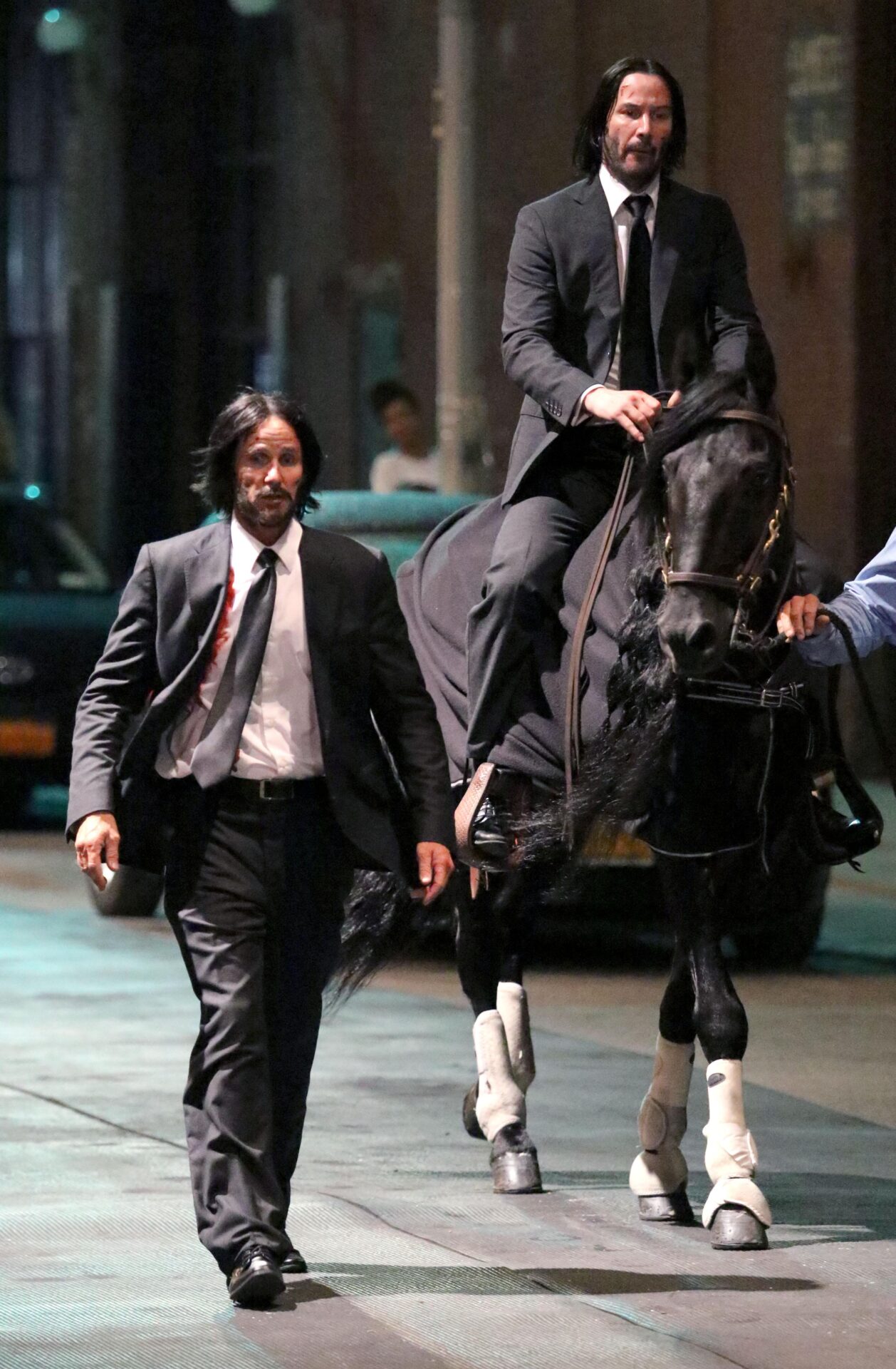 Keanu Reeves horses around with his stunt double on the set of John Wick 3 | The Sun
