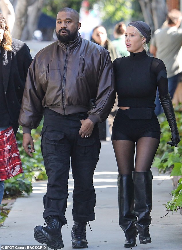 Kanye West And His Wife, Bianca Censori Appeared In Style Together At An Event In Dubai. Censori Caught Everyone's Attention With Her Chic Choice Between A Neutral Mini Dress And A Soldier-style Hat. 216 bao kanye west and his wife bianca censori appeared in style together at an event in dubai censori caught everyone s attention with her chic choice between a neutral mini dress and a soldier style hat 65684bdce629f Kanye West And His Wife, Bianca Censori Appeared In Style Together At An Event In Dubai. Censori Caught Everyone's Attention With Her Chic Choice Between A Neutral Mini Dress And A Soldier-style Hat.